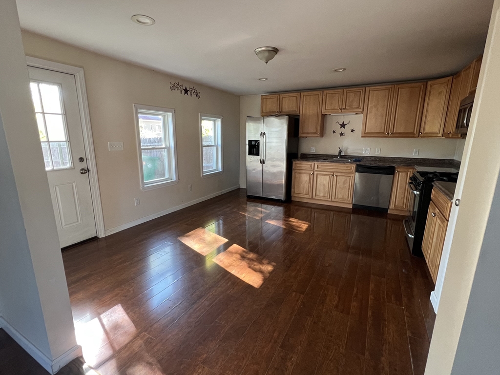 22 Forest Avenue Clinton, MA 01510 - Photo 4 of 13 a kitchen with stainless steel appliances granite countertop a refrigerator a sink dishwasher a stove and white countertops with wooden floor