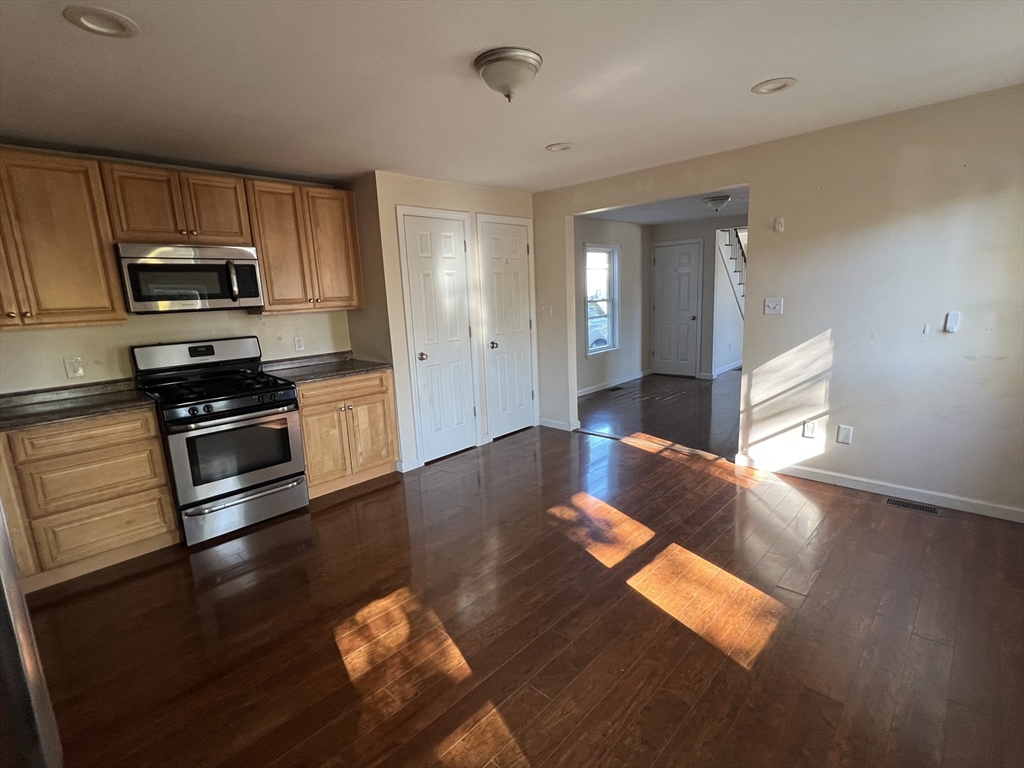 22 Forest Avenue Clinton, MA 01510 - Photo 6 of 13 a kitchen with stainless steel appliances granite countertop a stove and a refrigerator