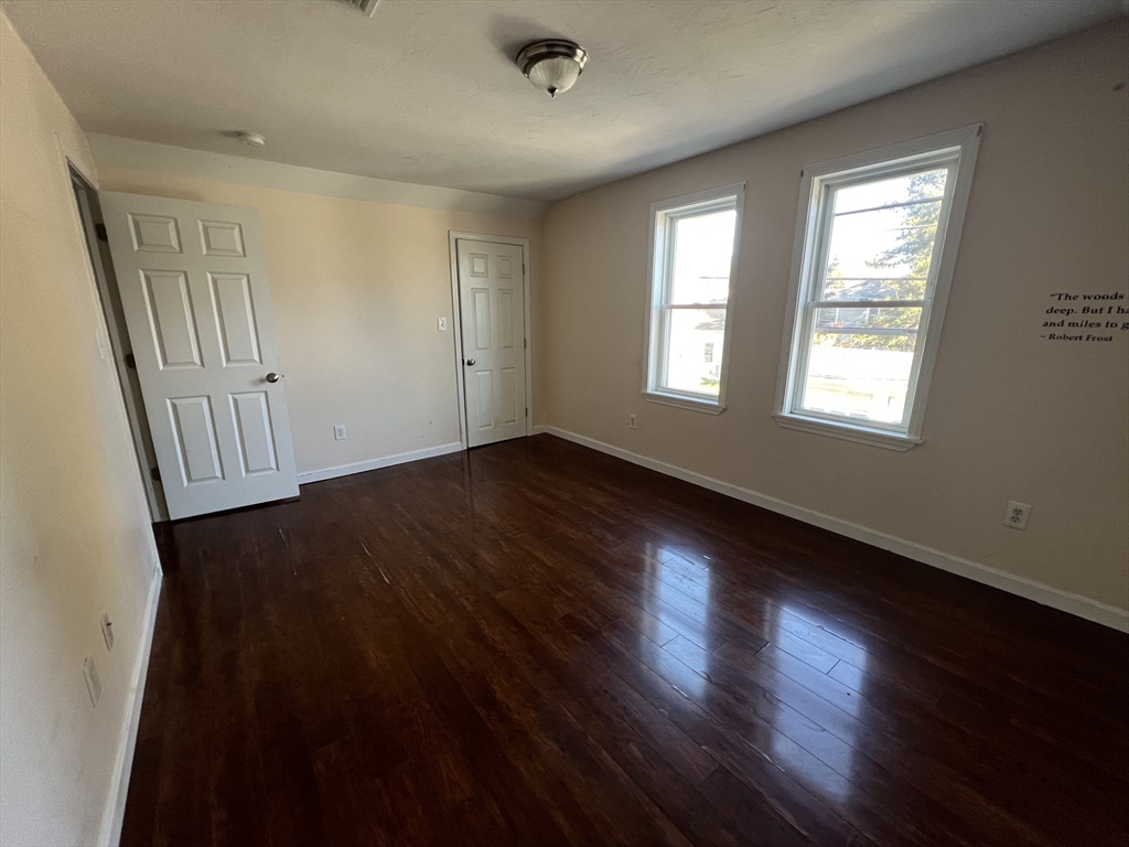 22 Forest Avenue Clinton, MA 01510 - Photo 10 of 13 a view of an empty room with wooden floor and a window