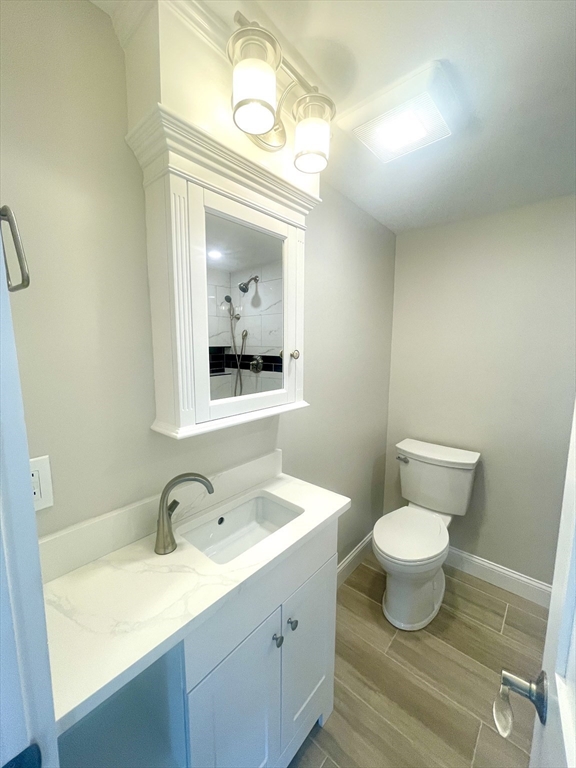 435 Newport Road, Unit 2 Hull, MA 02045 - Photo 11 of 38 a bathroom with a sink vanity granite toilet and a mirror