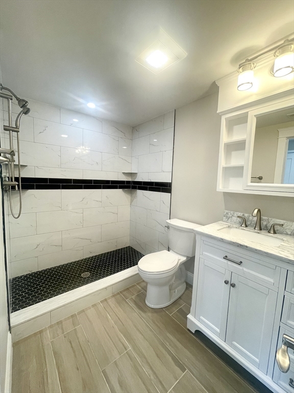 435 Newport Road, Unit 2 Hull, MA 02045 - Photo 23 of 38 a bathroom with a sink a toilet a mirror and vanity