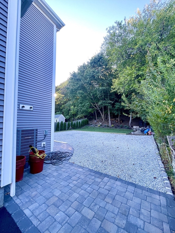 435 Newport Road, Unit 2 Hull, MA 02045 - Photo 37 of 38 a view of a backyard with table and chairs plants and trees