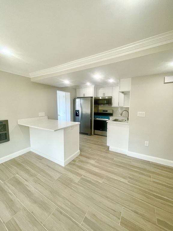 435 Newport Road, Unit 2 Hull, MA 02045 - Photo 4 of 38 a view of kitchen with wooden floor