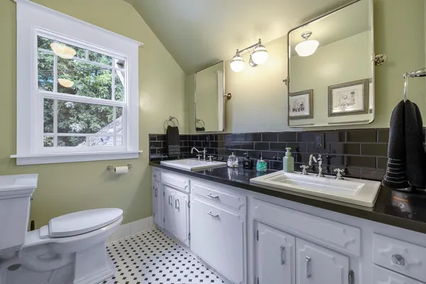 a view of a hallway with a chair and dining table view