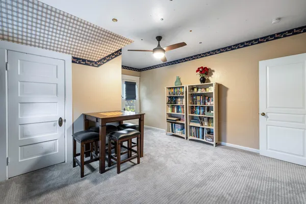 a view of a dining room with furniture and a chandelier