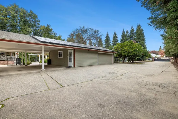 a view of a house with backyard and porch