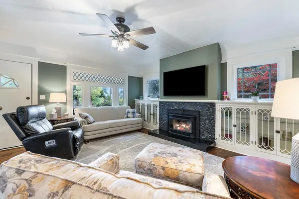 a living room with furniture a fireplace and a flat screen tv