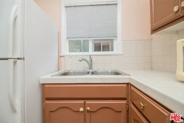 a kitchen with a stove and a window