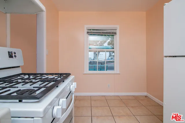 a kitchen with a white stove top oven and refrigerator