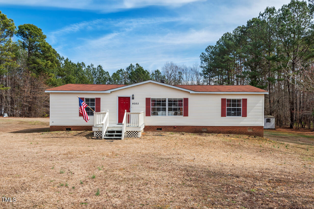 4082 Culbreth Road Stem, NC 27581 - Photo 29 of 33 a view of a house with backyard and sitting area