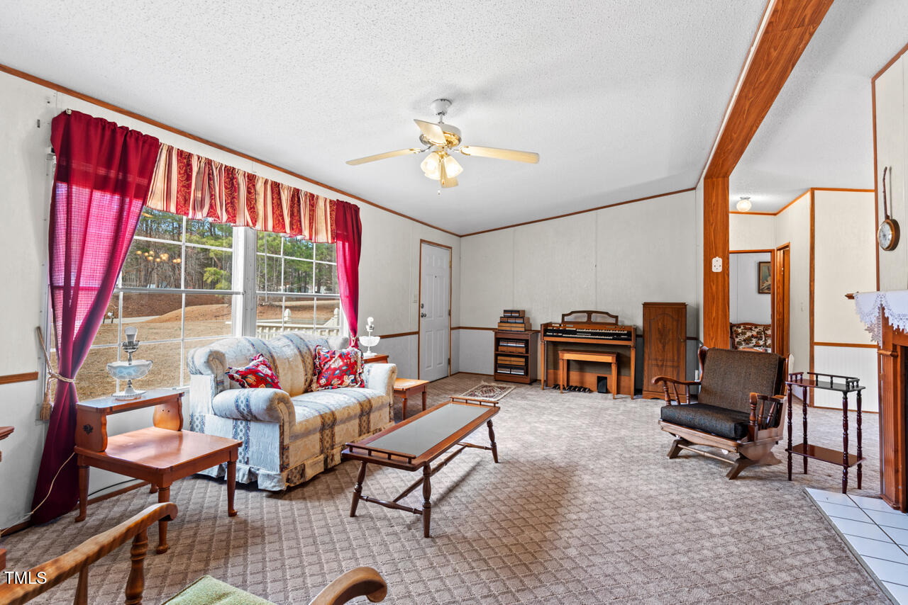 4082 Culbreth Road Stem, NC 27581 - Photo 8 of 33 a living room with furniture and a floor to ceiling window
