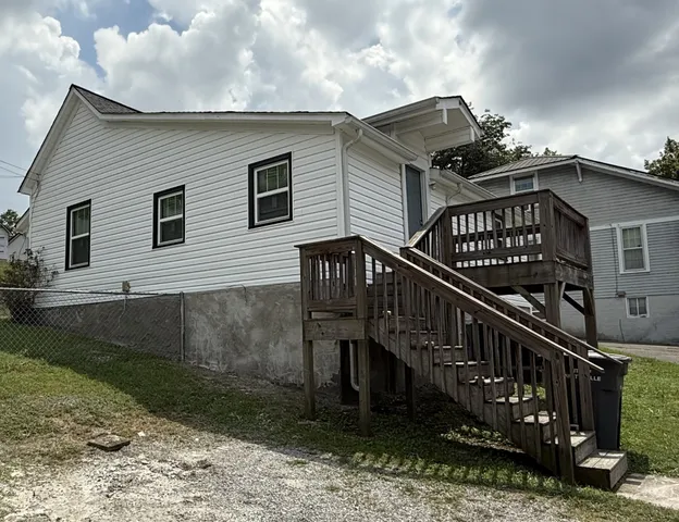 a view of a house with wooden deck