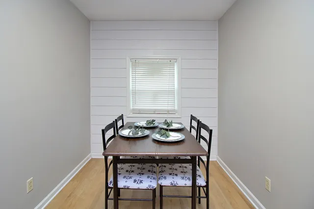 a view of a dining room with furniture and window