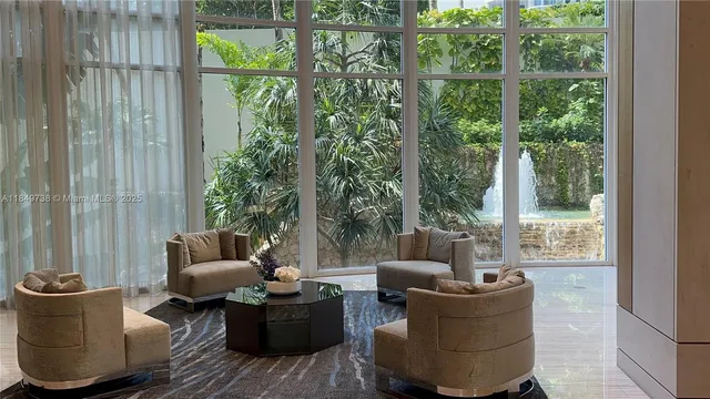 a lobby with furniture and floor to ceiling window