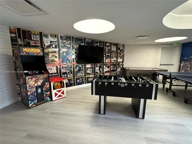 a living room with furniture a piano and a fireplace