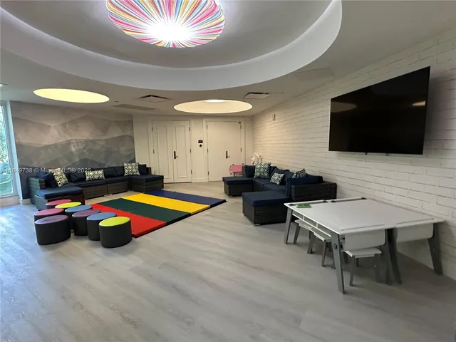 a living room with furniture and a floor to ceiling window