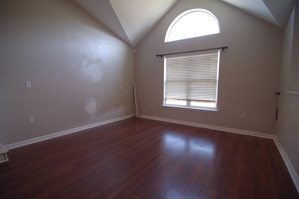 4759 West Westvale Road Northeast Roanoke, VA 24019 - Photo 2 of 13 an empty room with wooden floor and windows