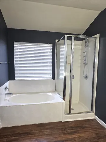 a bathroom with a bathtub and a shower