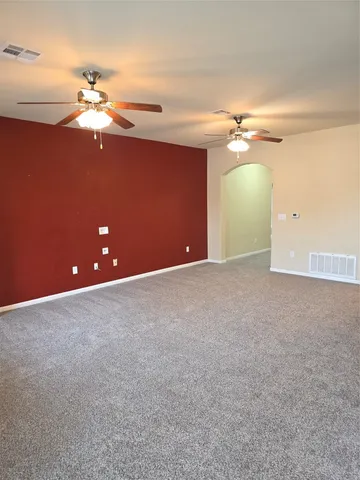 a view of an empty room with a fan
