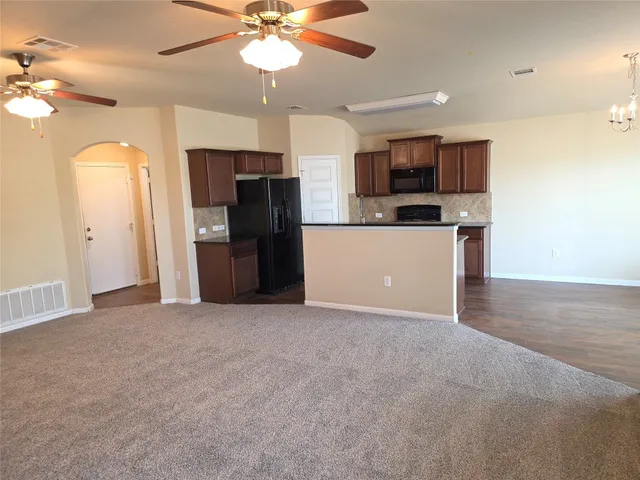 a view of a kitchen with a sink and stainless steel appliances