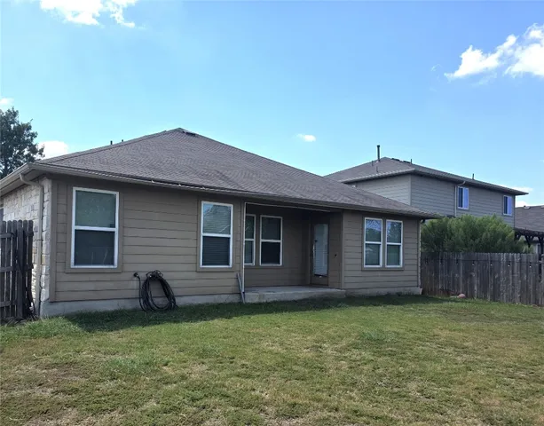 a backyard of a house with barbeque oven