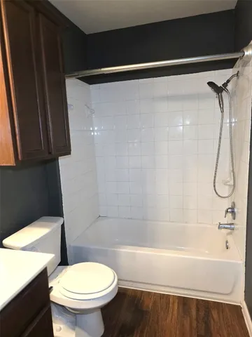 a bathroom with a shower a toilet and a sink