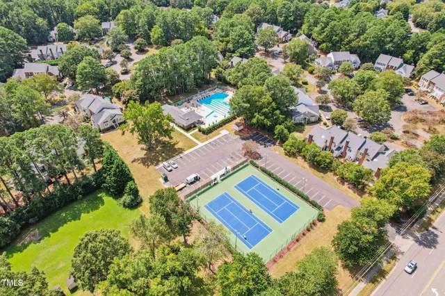 a kitchen with stainless steel appliances granite countertop a refrigerator a sink dishwasher a stove and white countertops with wooden floor