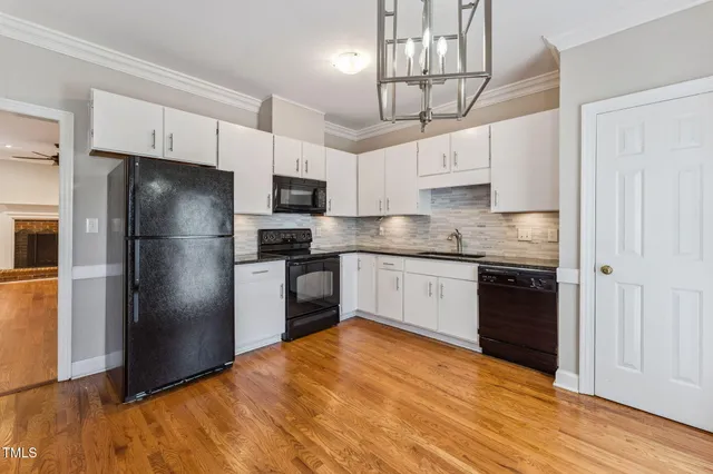 a view of a room with wooden floor closet and windows