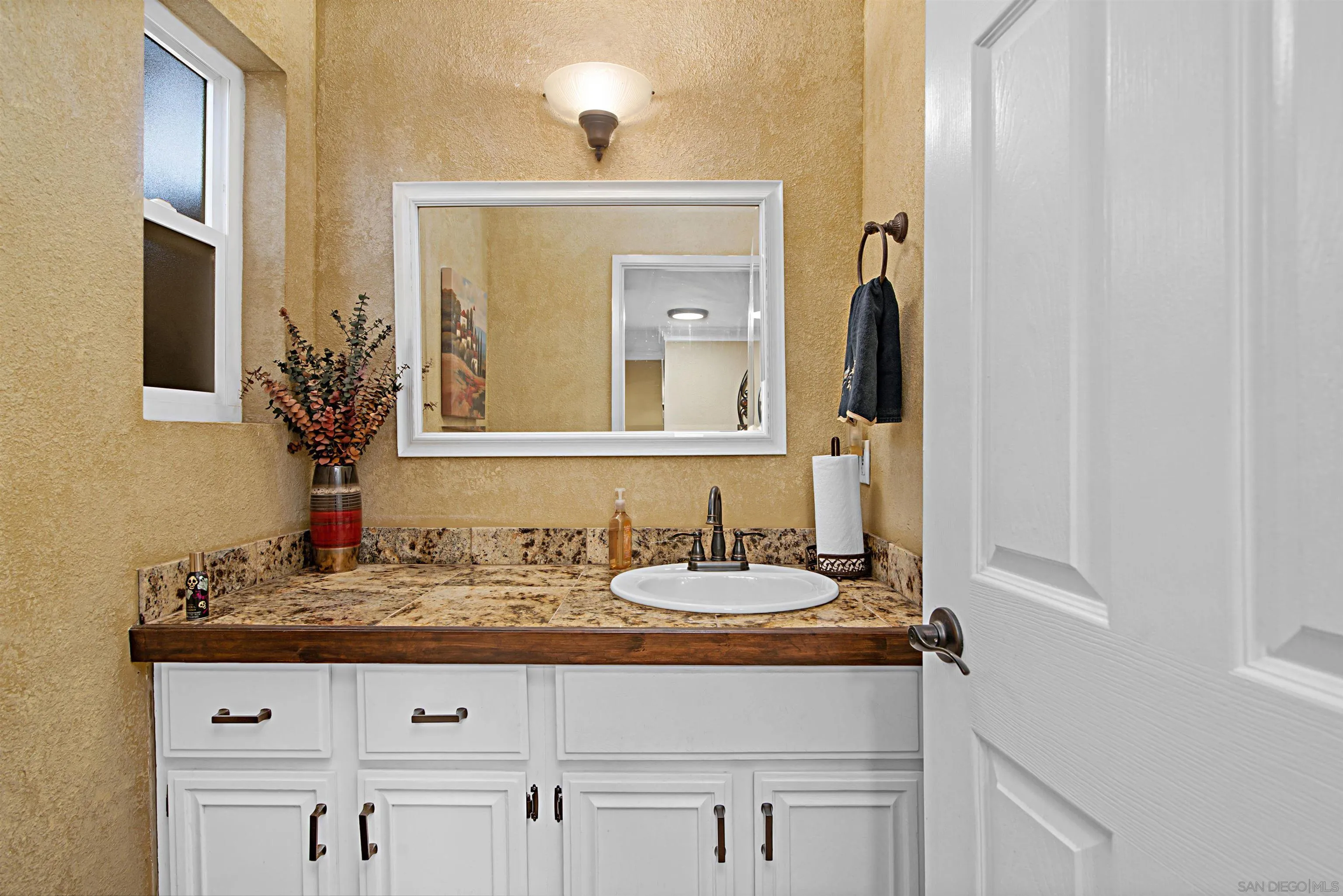 9917 Aviary Drive San Diego, CA 92131 - Photo 19 of 40 a bathroom with a sink and a mirror