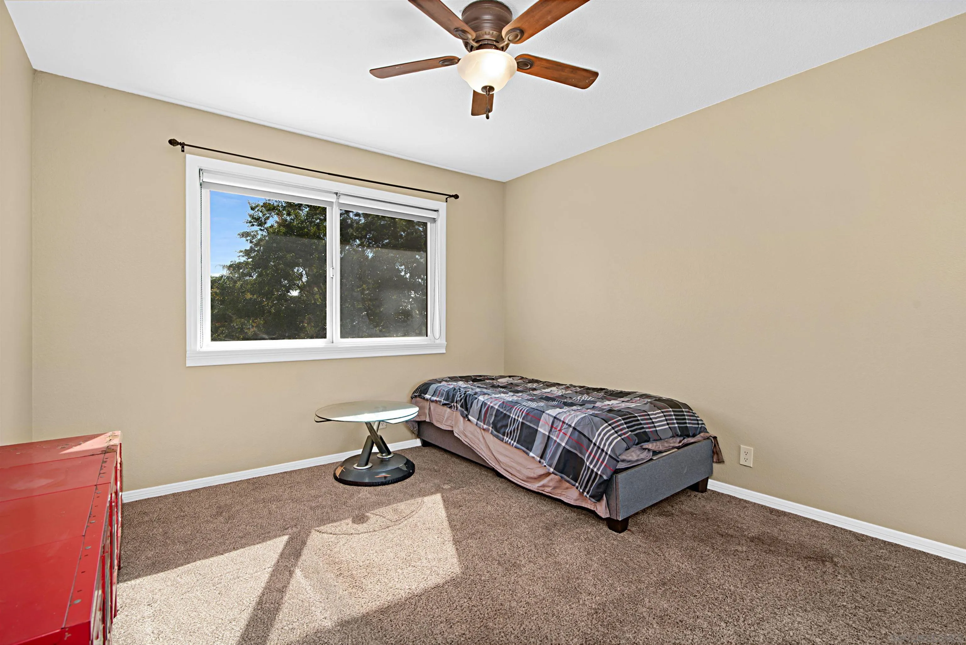 9917 Aviary Drive San Diego, CA 92131 - Photo 26 of 40 a living room with a bed furniture and a window