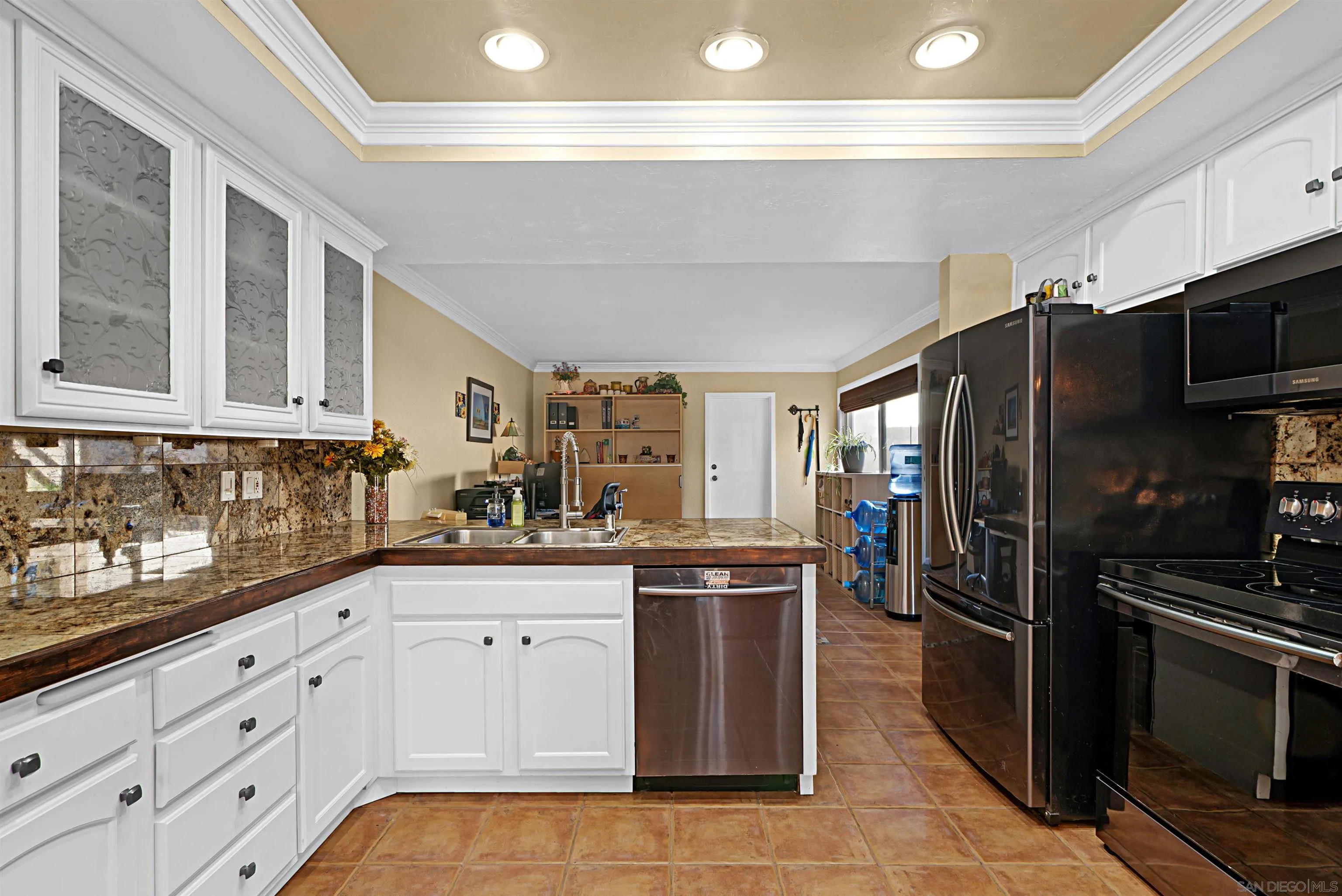 9917 Aviary Drive San Diego, CA 92131 - Photo 10 of 40 a kitchen with granite countertop a refrigerator stove and sink