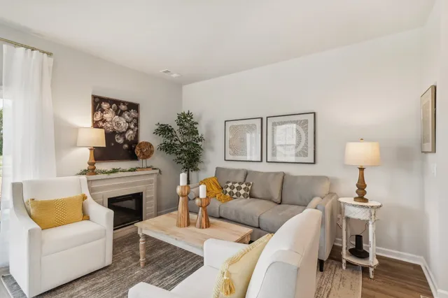 a living room with furniture a fireplace and a table