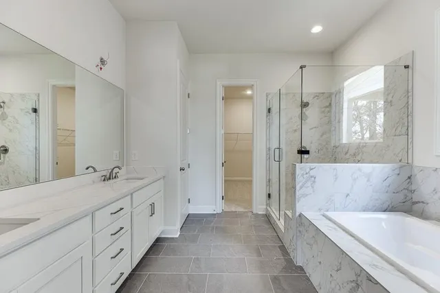 a bathroom with a double vanity sink toilet mirror and bathtub