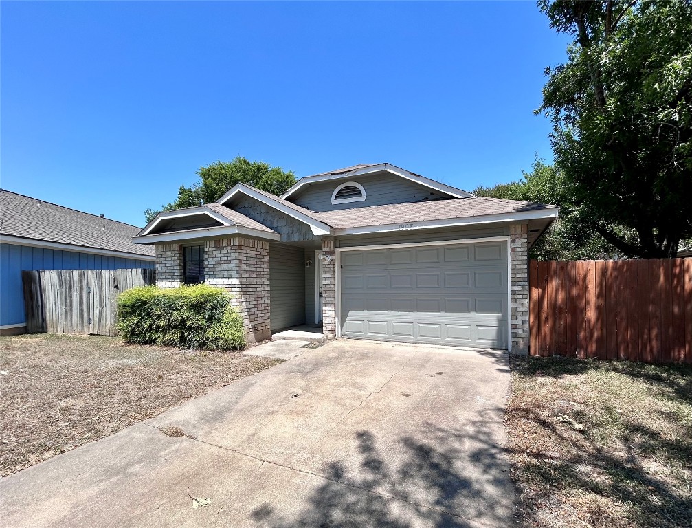 1908 Rainy Meadows Drive Austin, TX 78758 - Photo 1 of 17 a front view of a house with a yard and garage