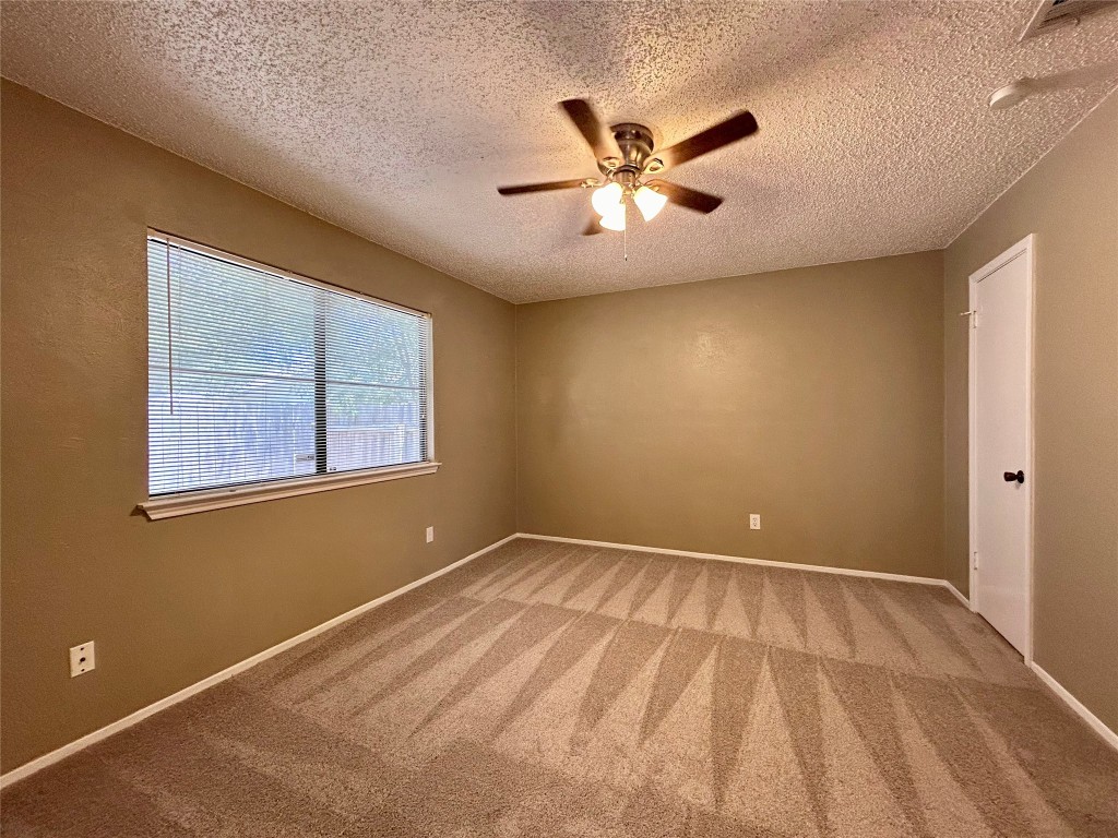 1908 Rainy Meadows Drive Austin, TX 78758 - Photo 11 of 17 a view of an empty room with window and chandelier fan