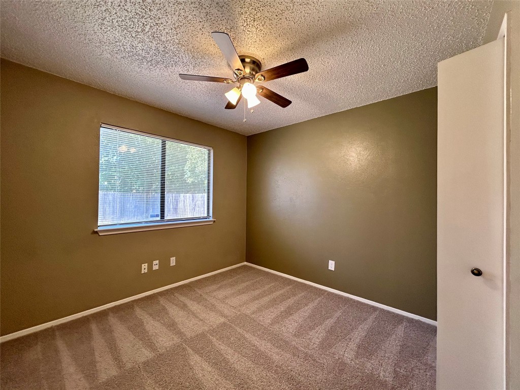 1908 Rainy Meadows Drive Austin, TX 78758 - Photo 12 of 17 a view of an empty room with a window