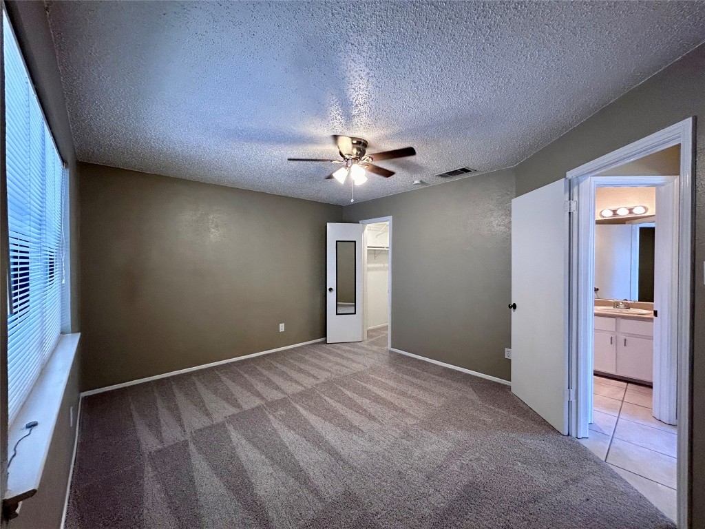 1908 Rainy Meadows Drive Austin, TX 78758 - Photo 13 of 17 a view of an empty room with a window