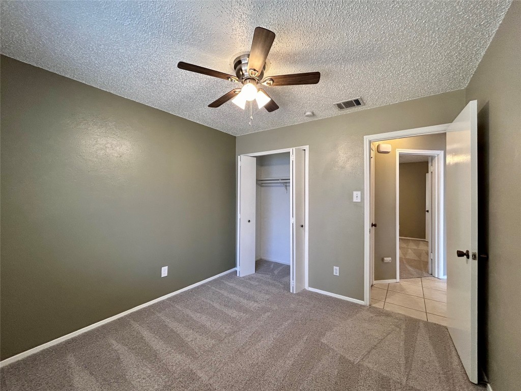 1908 Rainy Meadows Drive Austin, TX 78758 - Photo 14 of 17 an empty room with closet and a chandelier fan