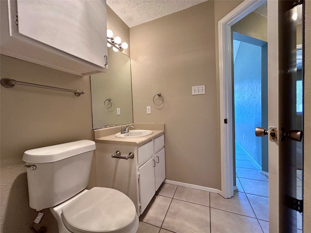 1908 Rainy Meadows Drive Austin, TX 78758 - Photo 10 of 17 a bathroom with a toilet sink and shower