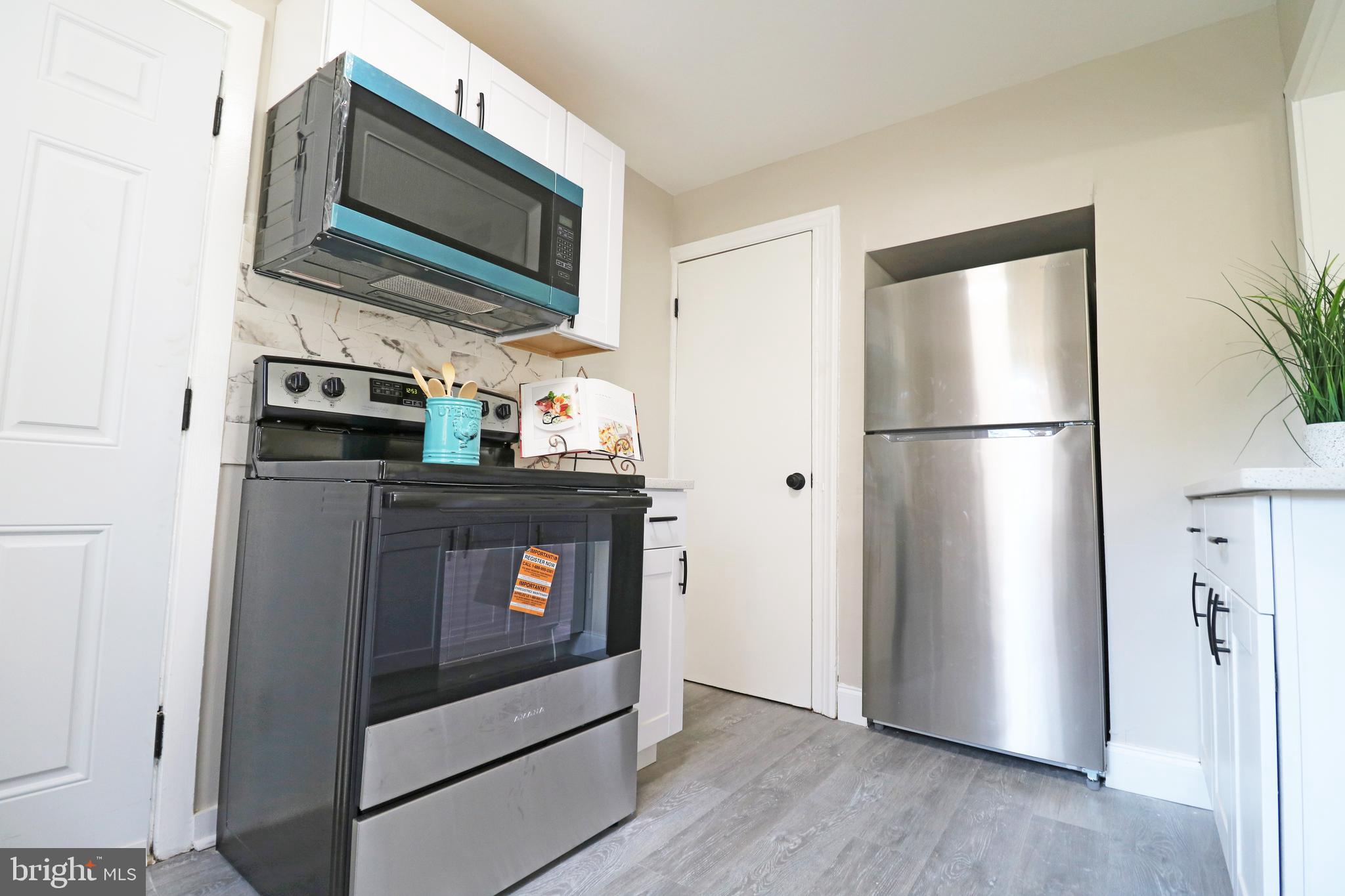 1016 Lamb Road Secane, PA 19018 - Photo 21 of 41 a kitchen with stainless steel appliances a refrigerator stove and microwave