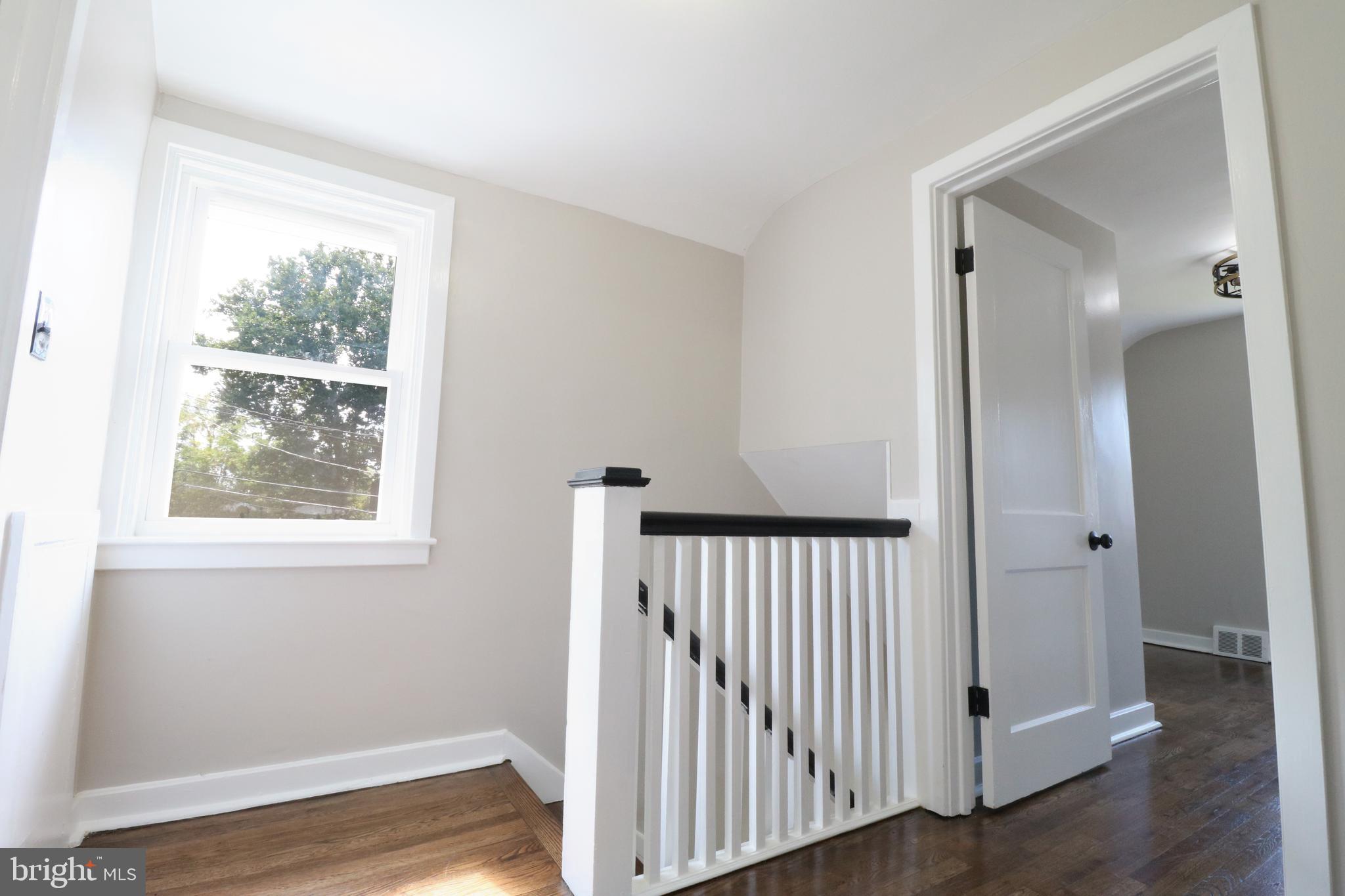 1016 Lamb Road Secane, PA 19018 - Photo 22 of 41 a view of a hallway with a window and wooden floor