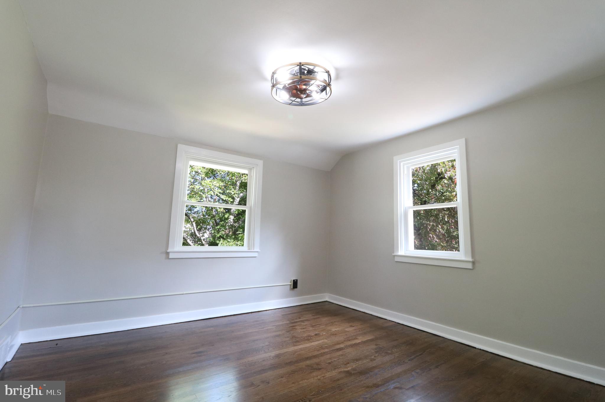1016 Lamb Road Secane, PA 19018 - Photo 30 of 41 a view of an empty room with a window and wooden floor