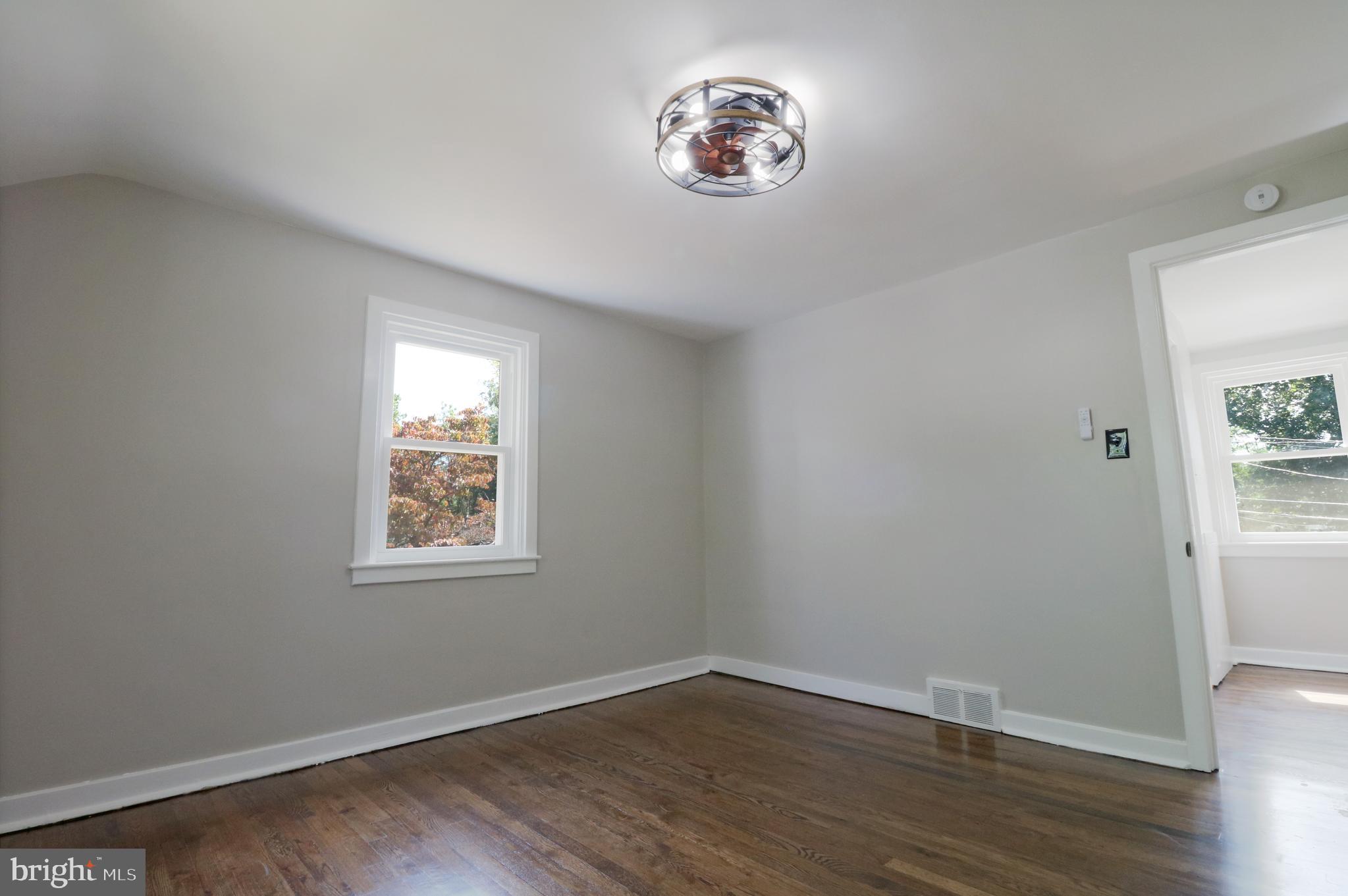 1016 Lamb Road Secane, PA 19018 - Photo 31 of 41 an empty room with a window and wooden floor