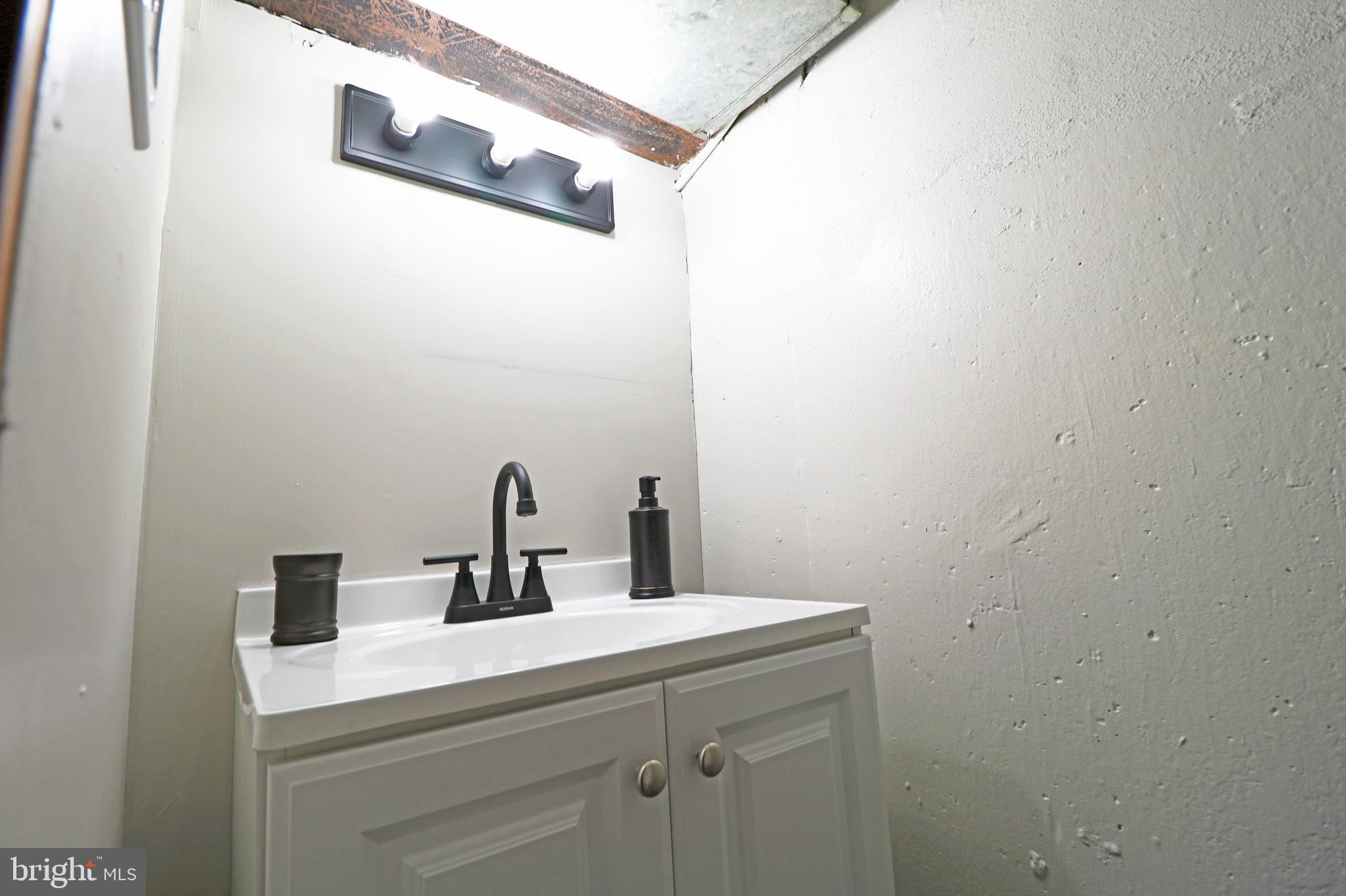 1016 Lamb Road Secane, PA 19018 - Photo 38 of 41 a bathroom with a sink and a mirror