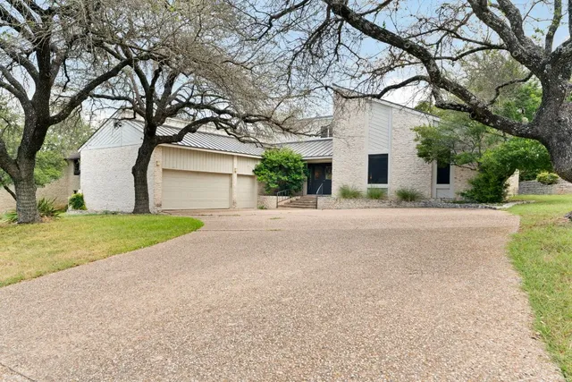 a front view of house with yard and trees