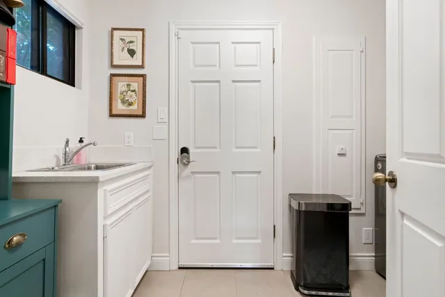 a living room with patio furniture and a floor to ceiling window