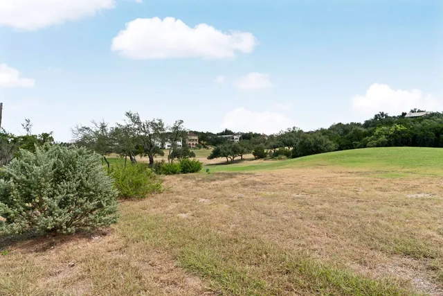 a front view of a house with garage and plants