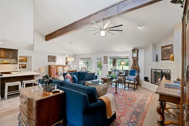 a living room with fireplace furniture and a flat screen tv