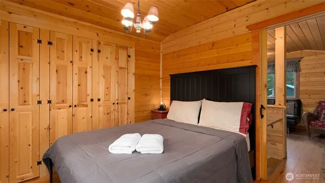 a bedroom with a bed and a chandelier