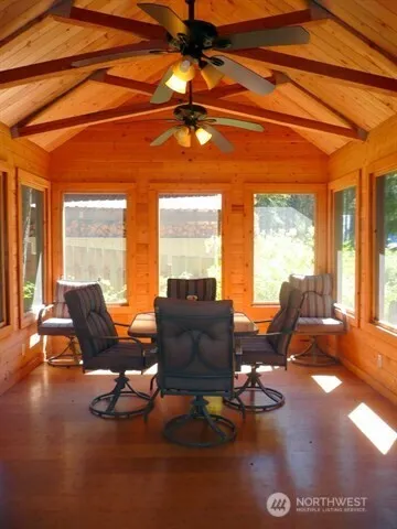 a living room with furniture and floor to ceiling windows